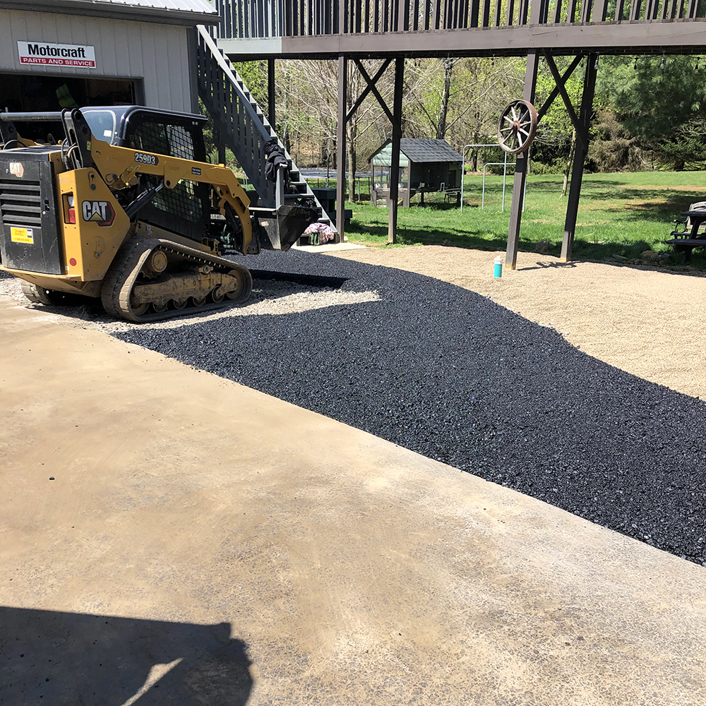 Harvey Paving crew laying blacktop with a paver and dump truck